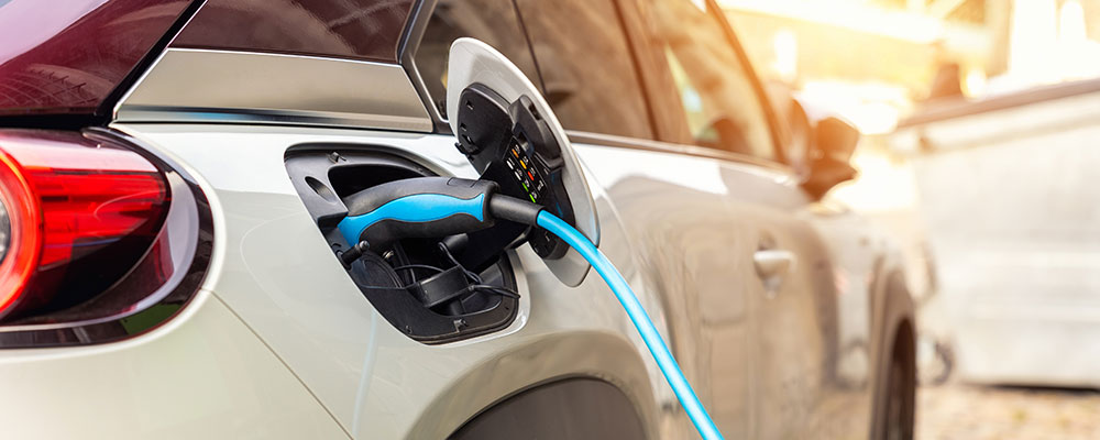 Electric vehicle plugged into charger
